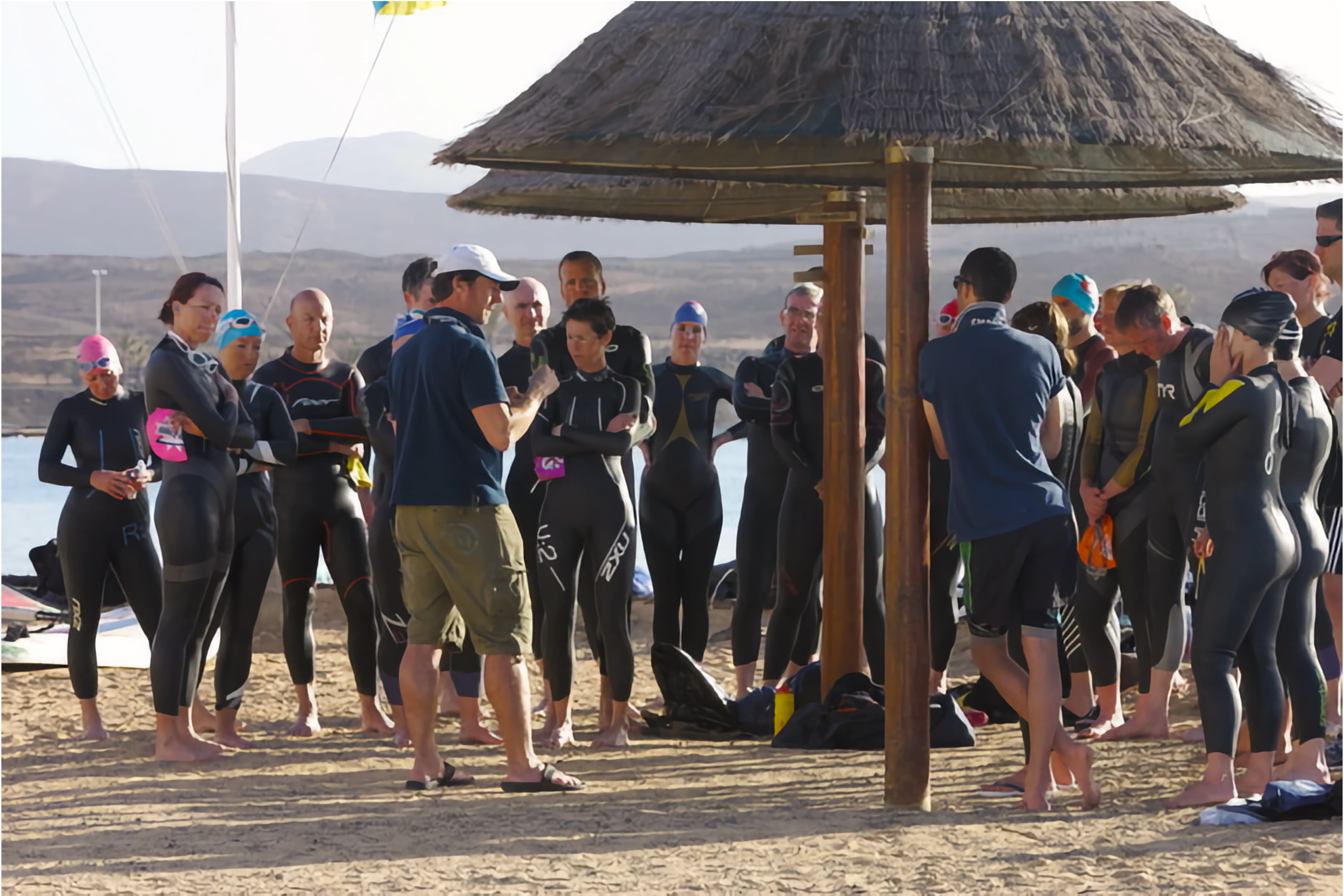 Group of people listening to Swim for Tri head coach Dan at coaching session